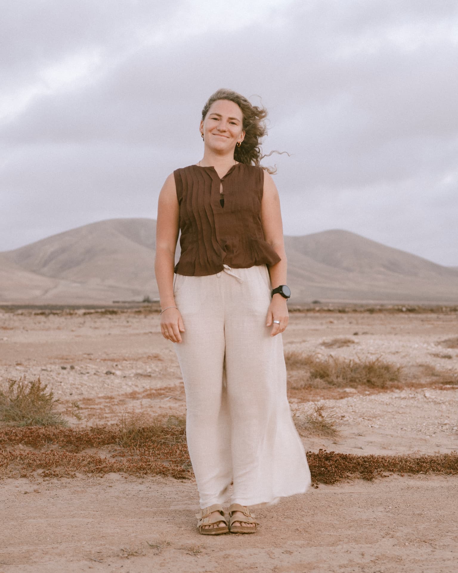 Elena standing in an open desert landscape